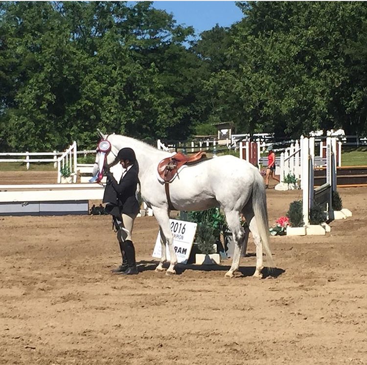 Rossland Stables rider receiving hunter show ribbon